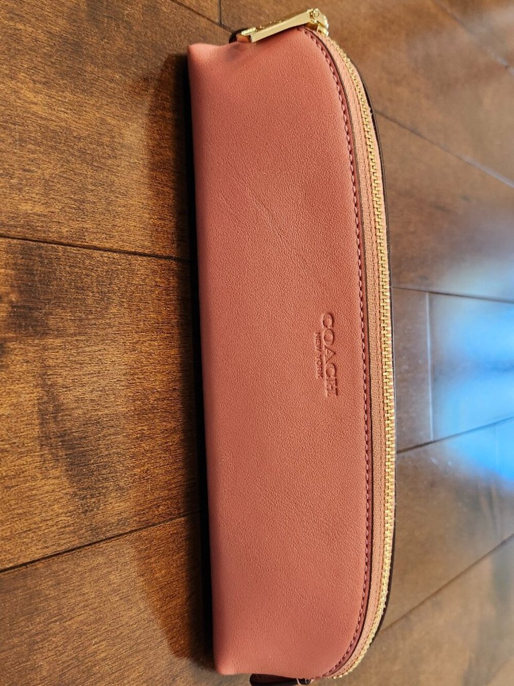 Coach smooth leather pencil case in the color gold/taffy